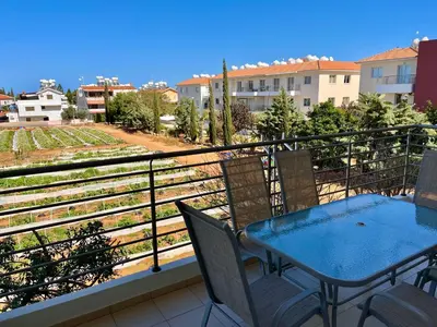 a balcony with a table and chairs on a balcony at Mythical Sands Holiday Apartment in Paralimni