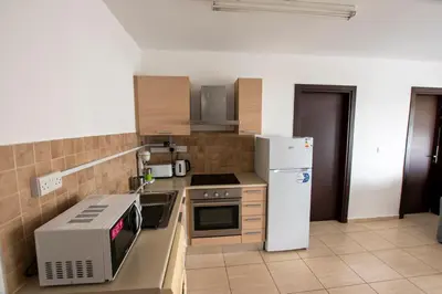 a kitchen with a microwave and a refrigerator at Glabur Stays - The Master Atelier - Nicosia City, Free Parking & Wifi, Welcomes You!!! in Nicosia
