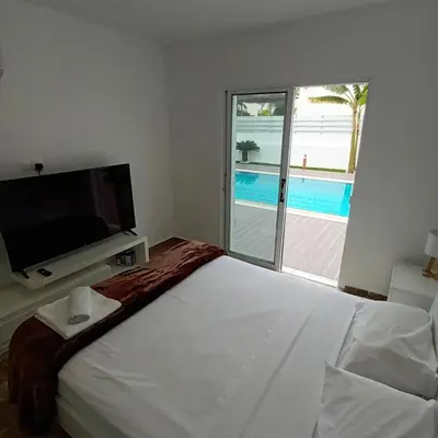 a bedroom with a bed and a tv and a window at Villa Aleksandar in Protaras
