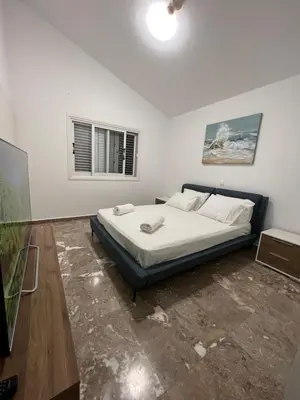 a bedroom with a bed and a window at Villa Aleksandar in Protaras