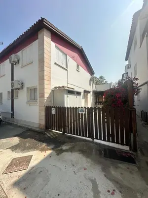 a house with a wooden fence in front of it at Leonidas Seaside in Meneou