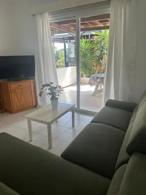 a living room with a couch and a table at Leonidas Seaside in Meneou