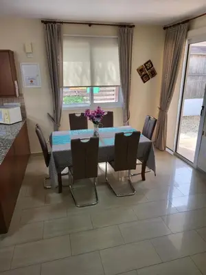 a dining room with a table and chairs at Villa Joia in Ayia Napa