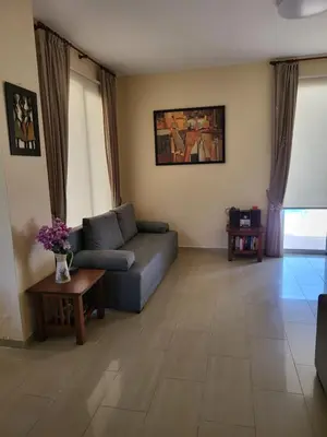 a living room with a couch and a table at Villa Joia in Ayia Napa