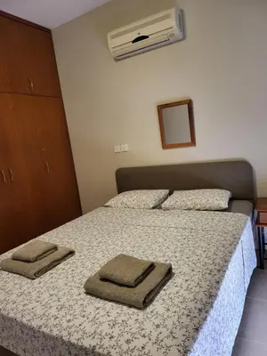 a bedroom with a bed with two towels on it at Villa Joia in Ayia Napa