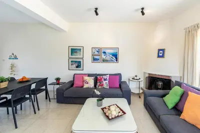 a living room with two couches and a table at Cape Greco Palm Trees Villa in Ayia Napa