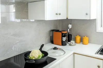 a kitchen with a bowl of cabbage on a stove at Cape Greco Palm Trees Villa in Ayia Napa