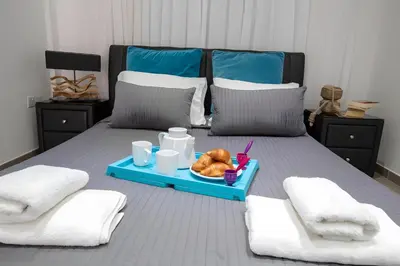 a bed with a tray of food on it at Sun & Sea Seaview Apartment in Protaras