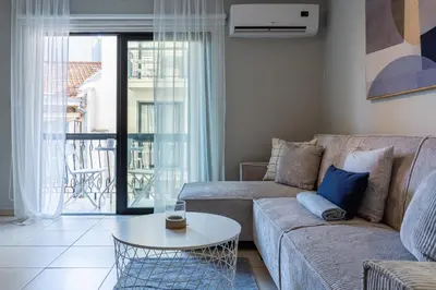a living room with a couch and a table at Gitane 1-Bedroom Apartment in Larnaca in Larnaka