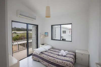 a bedroom with a bed and a balcony at Peaceful Cozy Home Great Location in Protaras