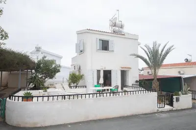 a white house with a fence in front of it at Peaceful Cozy Home Great Location in Protaras
