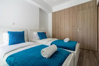 two beds in a room with blue and white at Crystal 2-Bedroom Apartment in Larnaca in Larnaka