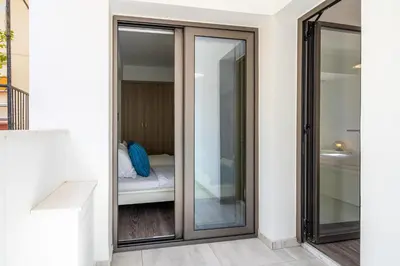 a sliding glass door leading to a bedroom in a house at Crystal 2-Bedroom Apartment in Larnaca in Larnaka