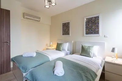 two beds sitting next to each other in a room at Celeste 3-Bedroom Apartment in Larnaca in Larnaka