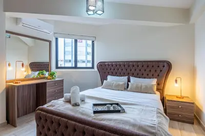 a bedroom with a large bed with a tray on it at Celeste 3-Bedroom Apartment in Larnaca in Larnaka
