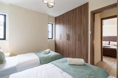a bedroom with two beds with towels on them at Celeste 3-Bedroom Apartment in Larnaca in Larnaka