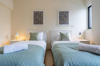 two beds sitting next to each other in a bedroom at Celeste 3-Bedroom Apartment in Larnaca in Larnaka