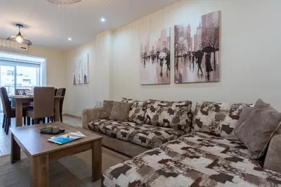 a living room with a couch and a table at Celeste 3-Bedroom Apartment in Larnaca in Larnaka