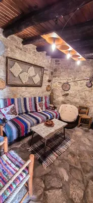 a living room with a couch and a table at Angels Traditional House in Arminou