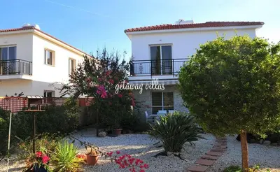 a large white house with a garden in front of it at LULA VILLA in Ayia Napa
