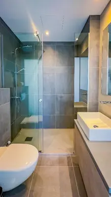a bathroom with a sink and a toilet and a shower at Sunrise Beachfront Villas - Villa 1 in Paralimni