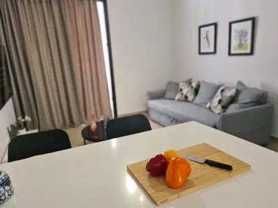 a table with a cutting board with vegetables on it at STAY Anemone 20 in Protaras