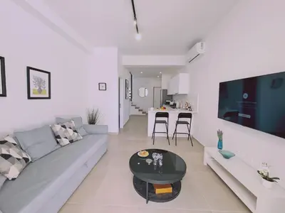a living room with a couch and a table at STAY Anemone 20 in Protaras