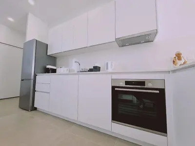 a white kitchen with a stove and a refrigerator at STAY Anemone 20 in Protaras