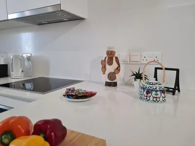a kitchen counter with a teddy bear and a bowl of food at STAY Anemone 20 in Protaras