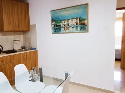 a kitchen with a painting on the wall at Palm Sea Suite 17 in Larnaka