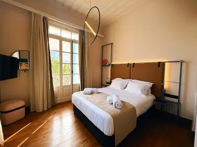 a bedroom with a large bed with towels on it at Heart Hotel in Limassol