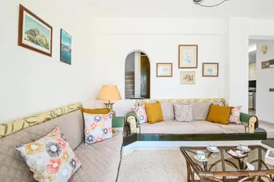 a living room with a couch and a table at Villa 361-Walk to Protaras Fig Tree Bay & Amenities in Protaras