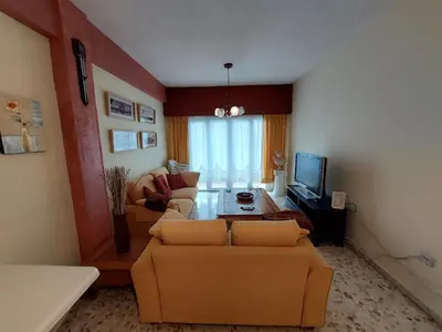 a living room with two couches and a television at Kyri's Place Larnaca in Larnaka