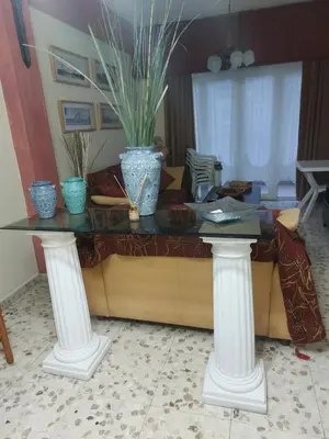a table with two vases on top of it at Kyri's Place Larnaca in Larnaka