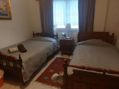 a bedroom with two beds and a window at Kyri's Place Larnaca in Larnaka