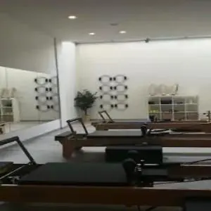 a room with wooden tables and a white wall at Mythical Spa Suite - GYM*Yoga Room*Pools in Protaras