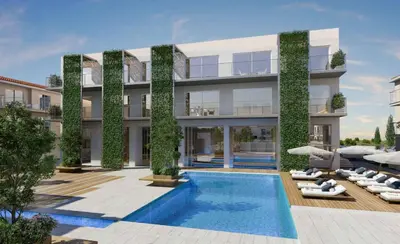 an external view of a building with a swimming pool at Mythical Spa Suite - GYM*Yoga Room*Pools in Protaras