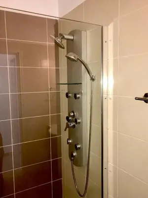 a shower with a shower head in a bathroom at Villa Poseidon in Pervolia
