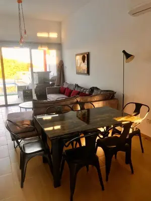 a living room with a table and a couch at Villa Poseidon in Pervolia