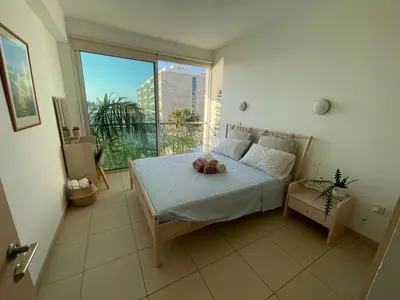 a bedroom with a bed and a large window at MagesticView seafront apartment in Protaras