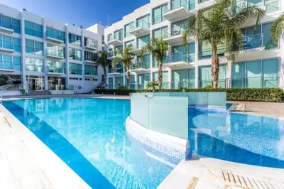 a swimming pool in front of a building at MagesticView seafront apartment in Protaras