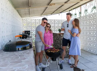 a group of people standing next to a grill at Amazing Cyprus Glamping Domes - Glamping Cyprus in Paphos City