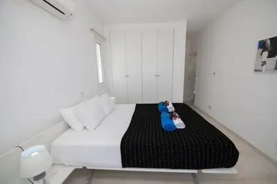 a bedroom with a bed with two dolls on it at Jasmine Sea Front Villa in Protaras