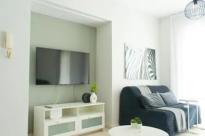 a living room with a couch and a flat screen tv at ALEX APARTMENT in Strovolos