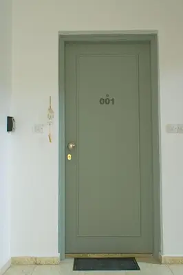 a green door with the number on it at ALEX APARTMENT in Strovolos
