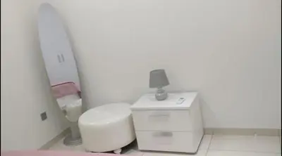 a white bathroom with a toilet and a mirror at Ayia Napa Luxury Apartment in Ayia Napa