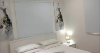 a bedroom with a white bed with pillows on it at Ayia Napa Luxury Apartment in Ayia Napa