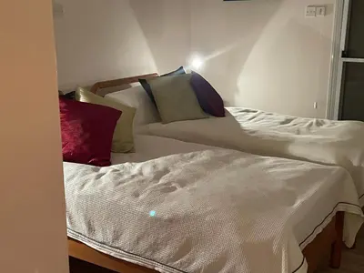 a room with a bed and a couch with pillows at Belleview Heights in Limassol