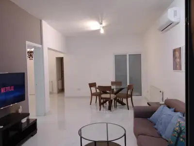 a living room with a couch and a table at Zelea Deluxe Apartment (BREAKBOOKING CY) in Limassol