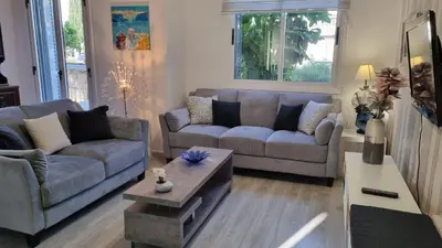 a living room with two couches and a coffee table at Elpida Lemon Garden House in Limassol